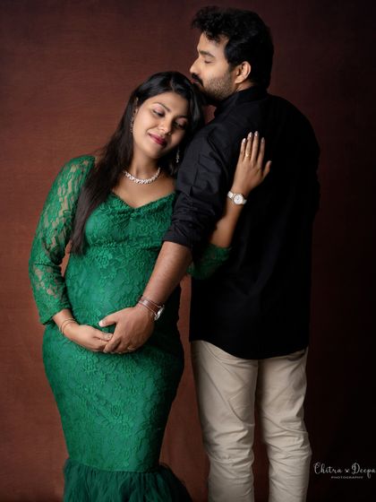 A loving embrace from behind. This pose is both romantic and beautifully highlights the baby bump.