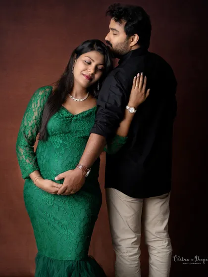 A loving embrace from behind. This pose is both romantic and beautifully highlights the baby bump.