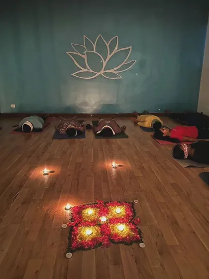 A candlelit floral mandala at the center of our healing circle. This arrangement is not just for beauty; it serves as a focal point to ground the energy of the room and honor our time together.