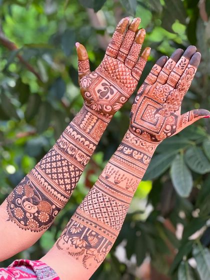 A unique design featuring different patterns on each hand, one with a peacock and the other with geometric shapes.