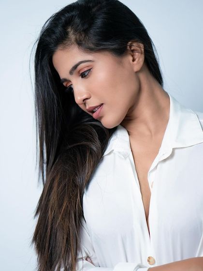 A thoughtful, downward-looking pose in a white shirt, adding a touch of moodiness to the portfolio.