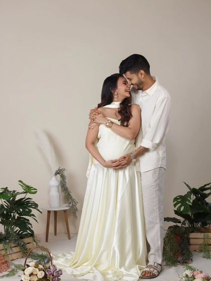An intimate moment within our studio's garden set. The couple's close embrace and happy expressions make this a warm and loving portrait, surrounded by the beauty of nature.