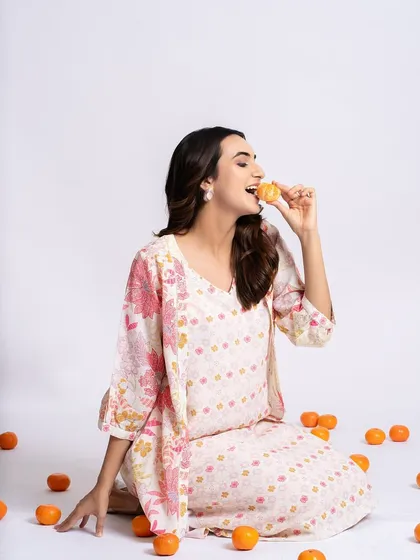 A fun and fresh look for a clothing brand shoot. The makeup is kept natural and glowing to match the playful vibe of the oranges and the printed outfit.