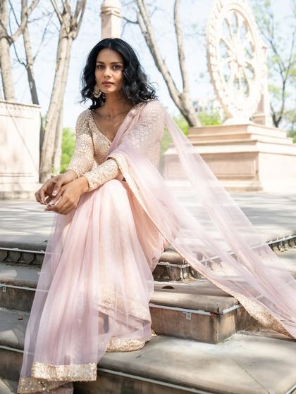Like a gentle breeze on a cool morning. This pale peach pre-stitched saree is refreshing and elegant.