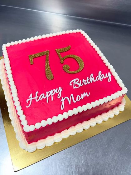A classic sheet cake for a 75th birthday that proves simple can be stunning. The vibrant pink frosting and glittering gold numbers make it a festive and delicious way to celebrate a major milestone.