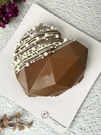 Our geometric heart pinata cake is a modern and stylish way to celebrate. Break it open to reveal a sweet surprise inside.