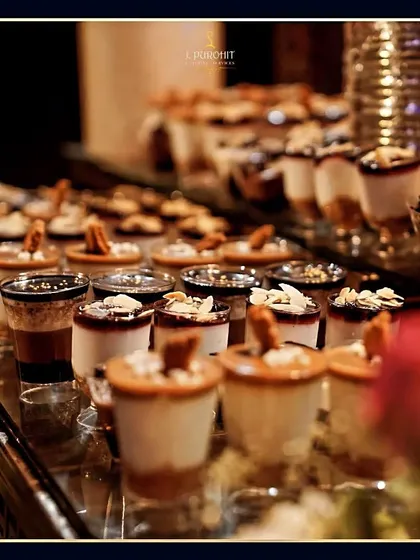 A beautiful display of my shot-glass desserts, featuring different layers and toppings. This presentation style is modern, elegant, and very popular at events.
