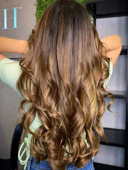 Stunning golden brown highlights. This transformation added so much warmth and dimension to her long hair, creating a beautiful, flowing style.