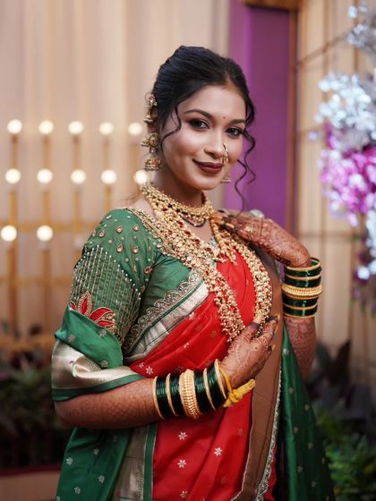 A radiant bridal portrait, capturing her looking directly at the camera with a warm and welcoming smile.