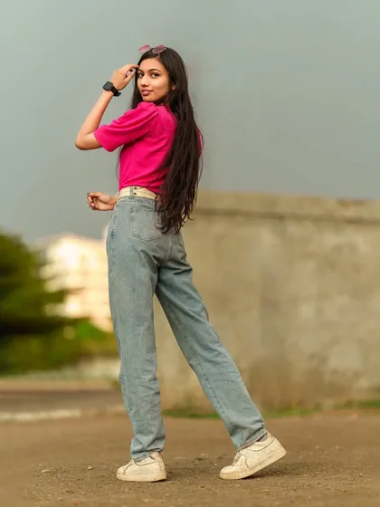 A dynamic back-quarter view, capturing the model in motion as she looks back at the camera.