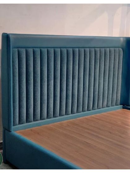 This bed features a striking wingback headboard with deep vertical channel tufting in a rich teal velvet. It's a bold and luxurious piece designed to be the undeniable star of the bedroom.