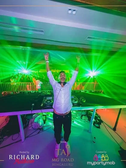In my element, hands up with the crowd, surrounded by a sea of green lasers. This shot from a New Year's Eve party captures that perfect moment of connection when the music and the lights all hit at once.