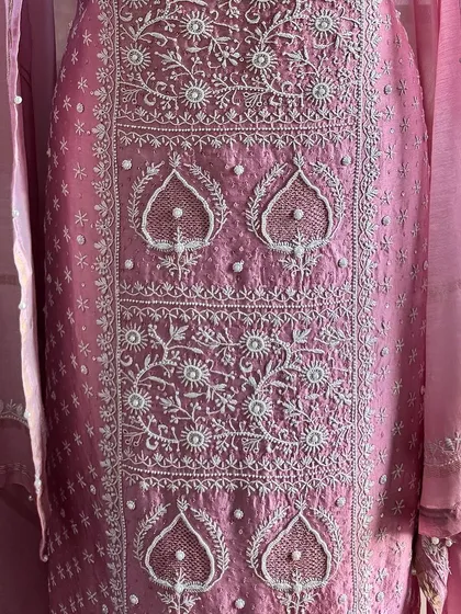 A straight-on view of the kurta's front panel, showing the symmetrical arrangement of the embroidered motifs.