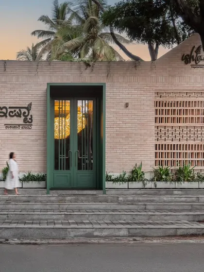 Another perspective of the Ishtaa storefront. The clean lines of the building, the texture of the brick, and the bold color of the door come together to define the restaurant's modern yet earthy brand identity.