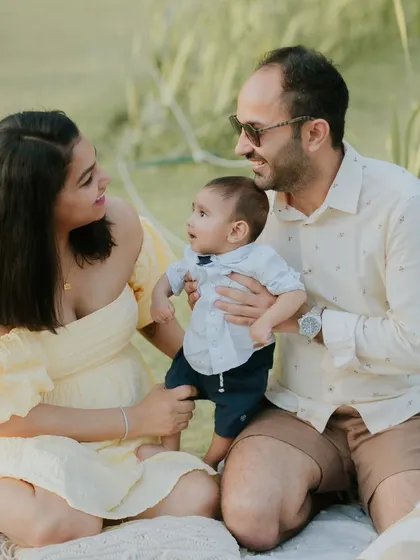A sunny day, a happy family. Outdoor sessions like this picnic theme are perfect for capturing natural and relaxed family interactions.