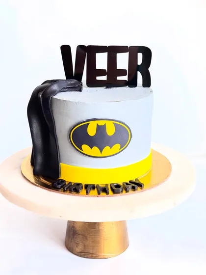 And here is the matching Batman cake for Veer. The design is similar to his twin's but with a cool grey and black theme, complete with the iconic bat symbol and cape.