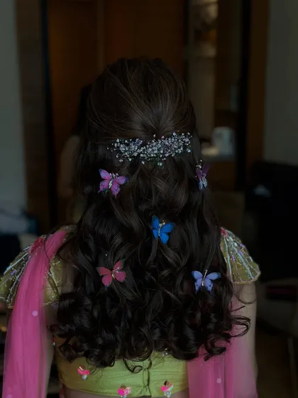 A final shot of the half-updo with butterflies, a fun and memorable choice for a Mehndi party.