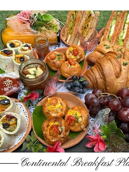 Start your day elegantly with my Continental Breakfast Platter. It features freshly baked croissants, cheese corn buns, grilled sandwiches, a salad in a jar, and fresh juice.