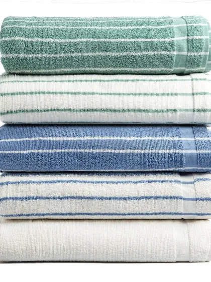 A tight, clean shot of a stack of folded towels in different colors. This image is excellent for showing the texture and range of colors available in a product line.
