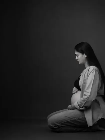 The same intimate portrait, presented in timeless black and white. This version removes all distractions, emphasizing the emotion, form, and beautiful play of light and shadow.