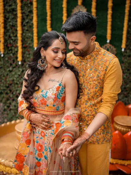 A sweet, intimate moment between the couple during their Haldi ceremony, their coordinated outfits adding to the festive atmosphere.