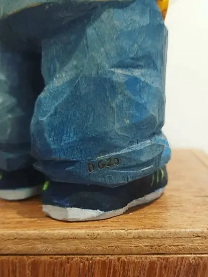 The final touches are what make each piece truly personal. Here, you can see a tiny signature I added to the shoe of a figurine, a small detail that adds a unique mark of craftsmanship.