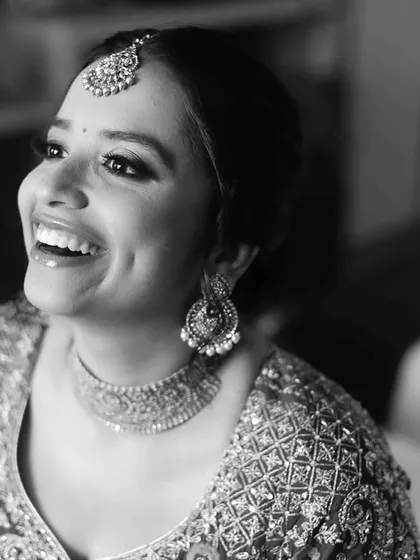 I have a special love for black and white portraits. They strip away all distractions and focus on the soul. This bride's radiant smile and the sheer happiness in her eyes create a timeless, classic wedding portrait.