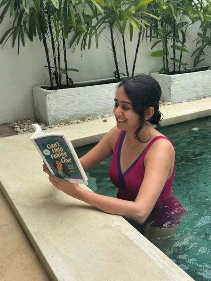 Another shot of me enjoying *Can't Help Faking in Love* in the pool. This book is set in Bangalore and captures the city's vibrant energy.