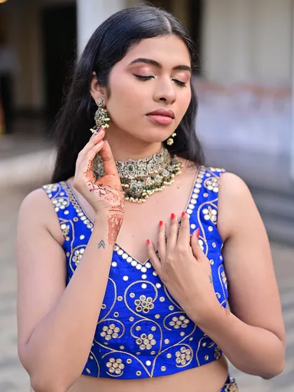 A close-up showing the soft, smoky eye and nude lip, a classic combination that works beautifully with the intricate jewelry and outfit.