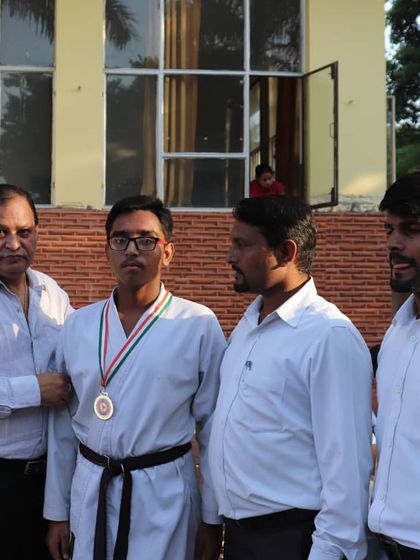 Receiving a medal at a local karate tournament. I stand by my students at every event, guiding them through their competitions.