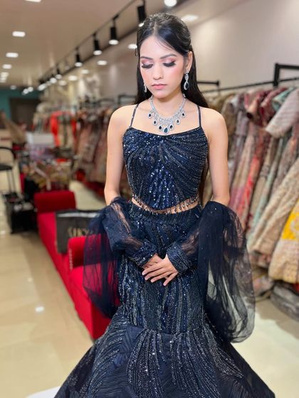 A stunning navy blue fish-cut lehenga with intricate beadwork. This is one of my most popular rental styles for cocktail parties and receptions, perfect for making a statement.