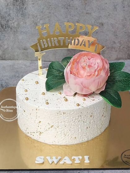 A minimalist cake with a textured white finish and a single, beautiful pink peony. Sometimes, less is more.