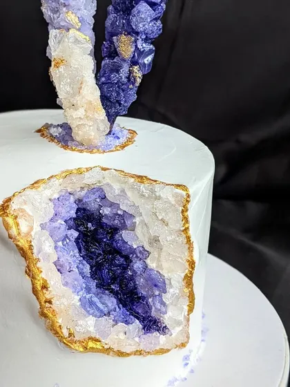 This is my signature geode cake, featuring a dramatic crystal cavity made from homemade rock candies and highlighted with edible gold. It's a modern, trendy design that brings a touch of geological wonder to your celebration.