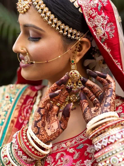 A detailed shot focusing on the bride's henna, jewelry, and soft eye makeup. Every element comes together in perfect harmony.