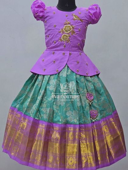 A lovely pastel combination of lavender and sea green. The peplum blouse has delicate bird embroidery.