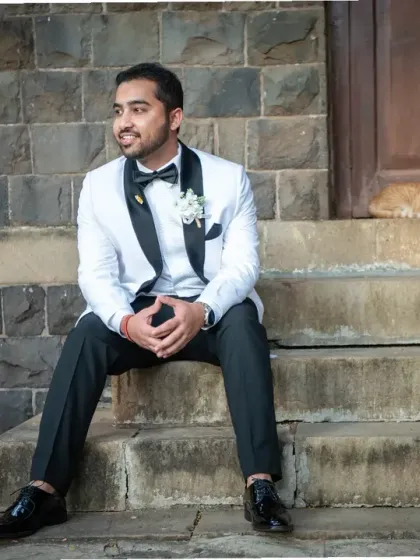 Even the cat wanted to be in the picture! A fun, candid moment of the groom sitting on the church steps, with an unexpected furry friend.