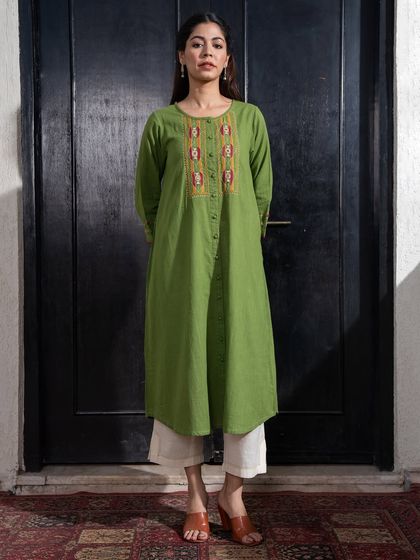 Our Paheli green A-line kurta, paired here with white pants, is a perfect example of a not-so-basic basic. The intricate embroidery on the yoke adds a touch of tradition to this effortless style.