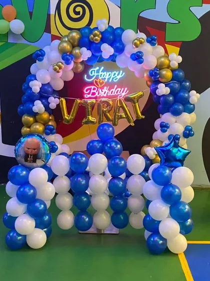 Another look at the Boss Baby birthday setup, showing the balloon arch, neon sign, and character-topped pillars. This theme is perfect for a little one with a big personality.