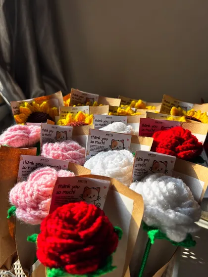 A whole batch of single-stem crochet roses and sunflowers ready for orders. Proof that love is better when it's handmade.