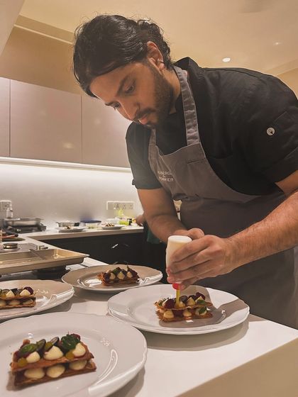 Adding the final touches to a mille-feuille dessert. This level of detail is what defines the fine dining experience I provide.