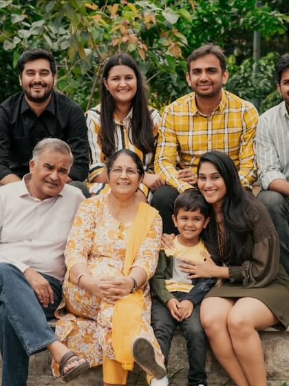A large, multi-generational family portrait taken outdoors. I love capturing the entire family, creating a priceless heirloom that includes grandparents, parents, and children.