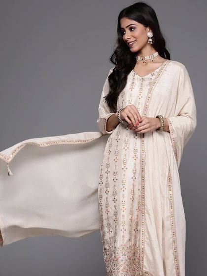 A cream kurta pant set with jacquard woven work. The subtle texture and elegant design make it a sophisticated choice for any occasion.