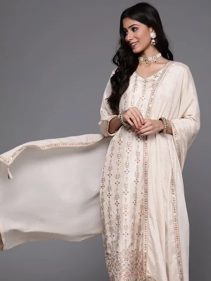 A cream kurta pant set with jacquard woven work. The subtle texture and elegant design make it a sophisticated choice for any occasion.