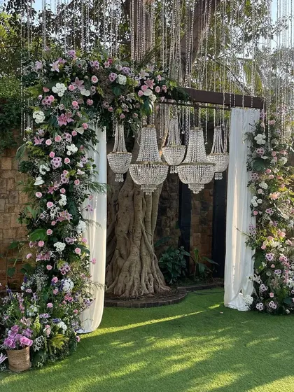 An enchanting entrance arch combining lush pastel florals with the timeless elegance of crystal chandeliers. This design creates a grand and magical welcome for your guests.