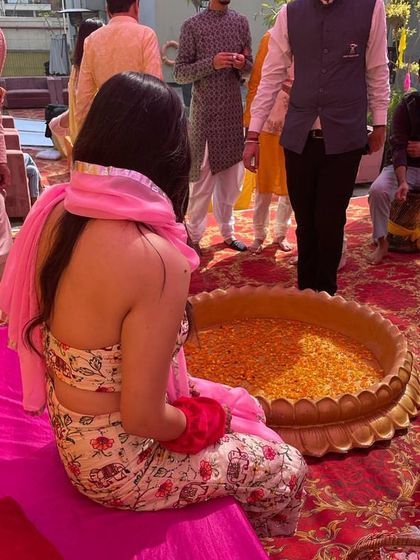 A back view of my custom Haldi outfit. The floral print and backless design with a simple pink dupatta was a comfortable and stylish choice for the poolside event.