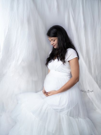 Serene in white. A simple, high-key setup with white fabric creates a soft, airy, and angelic feel for this timeless maternity portrait.