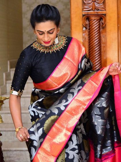 Our client Swapna Reddy in a best-selling black brocade saree with a pink and orange border, a truly striking combination.
