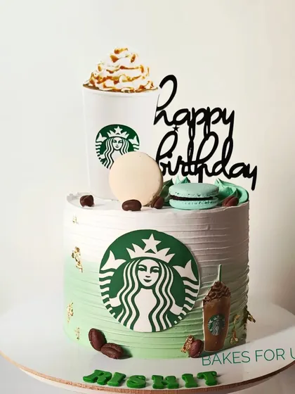 A Starbucks-themed cake for a coffee lover's birthday. The design features the iconic green logo, a Frappuccino topper, and edible coffee beans.