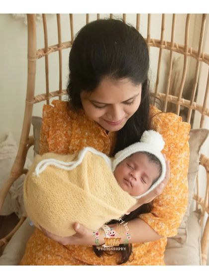 There's nothing like a cuddle with mum. This photo captures the warm, secure feeling of a baby being held in their mother's arms.