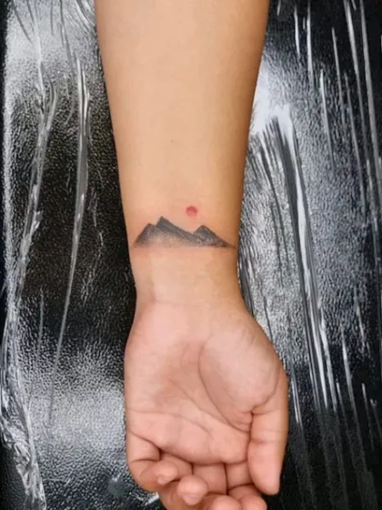 Another angle of the mountain tattoo, showing how it wraps around the wrist.